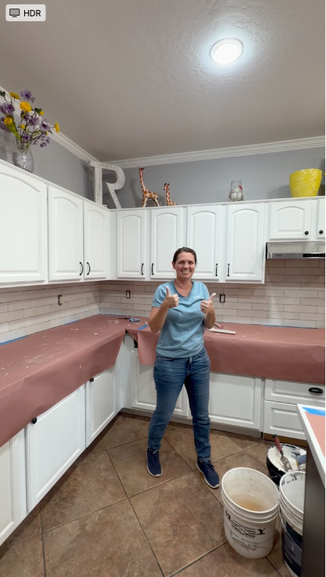 Laura giving thumbs up during a kitchen remodel